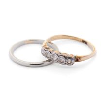 An 18ct white gold wedding band (ring size J 1/2) together with an 18ct yellow gold ring set with