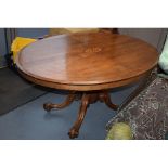 Victorian quarter veneered burr walnut oval table with ornately carved legs on casters, satinwood
