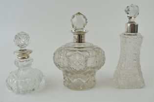 A large Edwardian silver collared and glass scent bottle, Chester 1905, 12cm tall, with 2 similar,