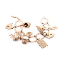 9ct rose gold horseshoe themed charm bracelet and containing 12 x 9ct charms, including padlock.