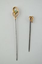 A pair of 9ct gold headed stick pins, one set turquoise, both on metal pins, gross weight 2.8 grams,