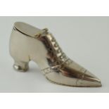 A novelty silver plated vesta case in the form of a shoe, dated 1910, 7cm long.