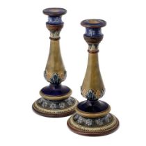 A pair of Doulton Lambeth stoneware candlesticks, baluster form, bands of leaves and flowers,