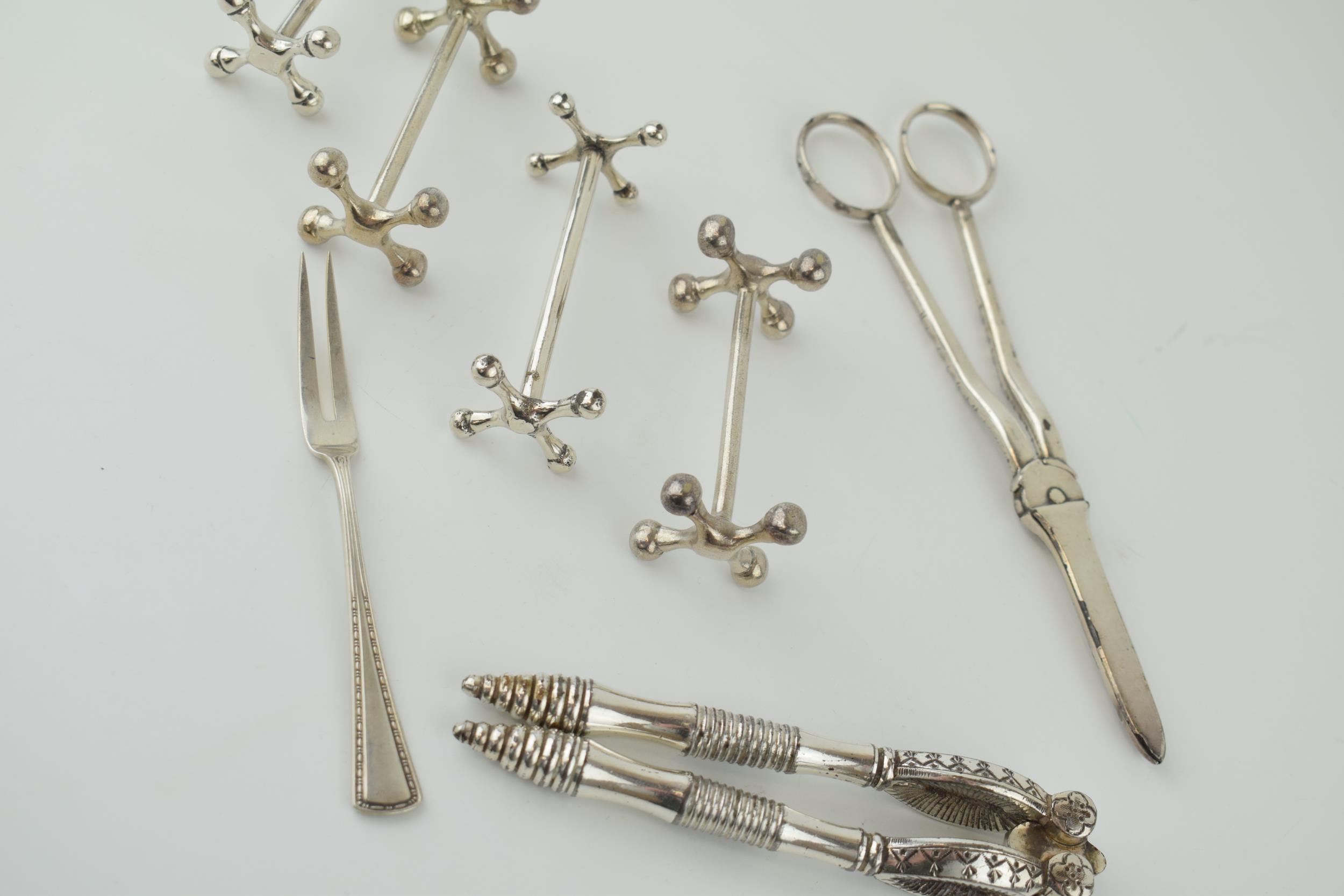 A collection of silver plated items to include knife rests, a nutcracker set and others. - Image 3 of 4