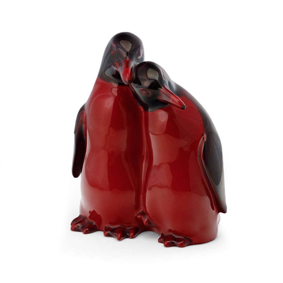 Royal Doulton flambe pair of huddling penguins 109, 15cm tall. In good condition with no obvious
