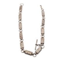 White metal (tests as silver) albert chain with ornate rectangular links with engraved floral