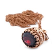 9ct rose gold fob, set oval-cut garnet, on fine 9ct chain (clasp af), total weight 9.9 grams.