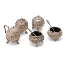 A cruet set in Indian Cutch silver to include mustard pots, salt and pepper set and lidded condiment
