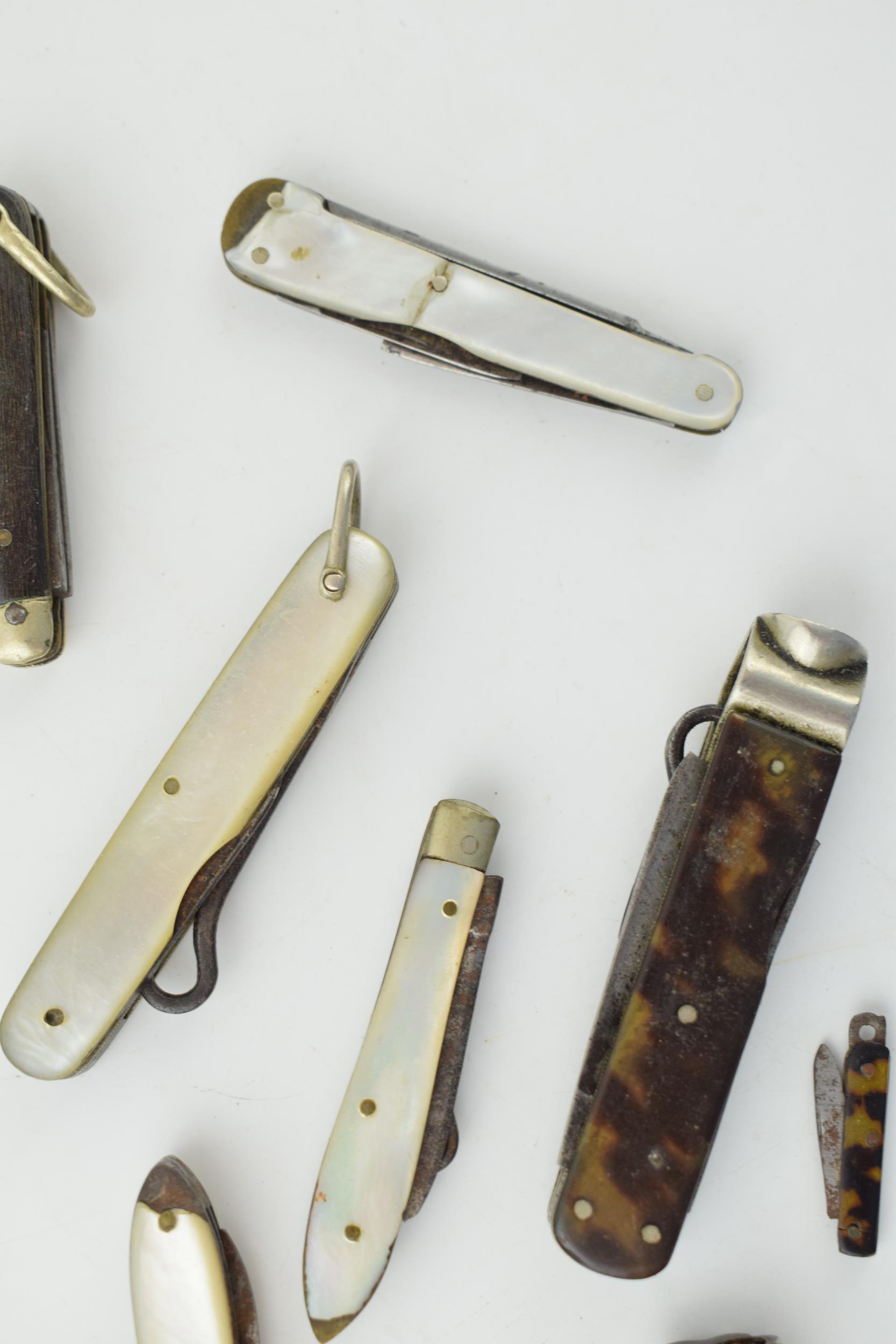 A collection of antique multifunction tool pocket knives to include mother pot pearl handled example - Image 6 of 9