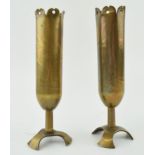 A pair of trench art vases, with shaped feet, to include ‘Souvenir’ and ‘Affecteux’, 18cm tall.