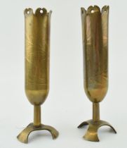 A pair of trench art vases, with shaped feet, to include ‘Souvenir’ and ‘Affecteux’, 18cm tall.