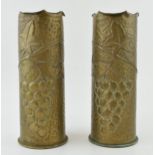 A pair of Trench Art vases, 23cm tall, with grape and vine decoration, possibly 1916.