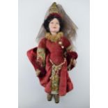 English doll, ceramic head likely manufactured in Stoke on Trent, c1930s. Red dress Chaucer's Tales.