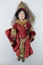 English doll, ceramic head likely manufactured in Stoke on Trent, c1930s. Red dress Chaucer's Tales.