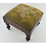 An antique footstool with tapestry decoration to top. Height 23cm.