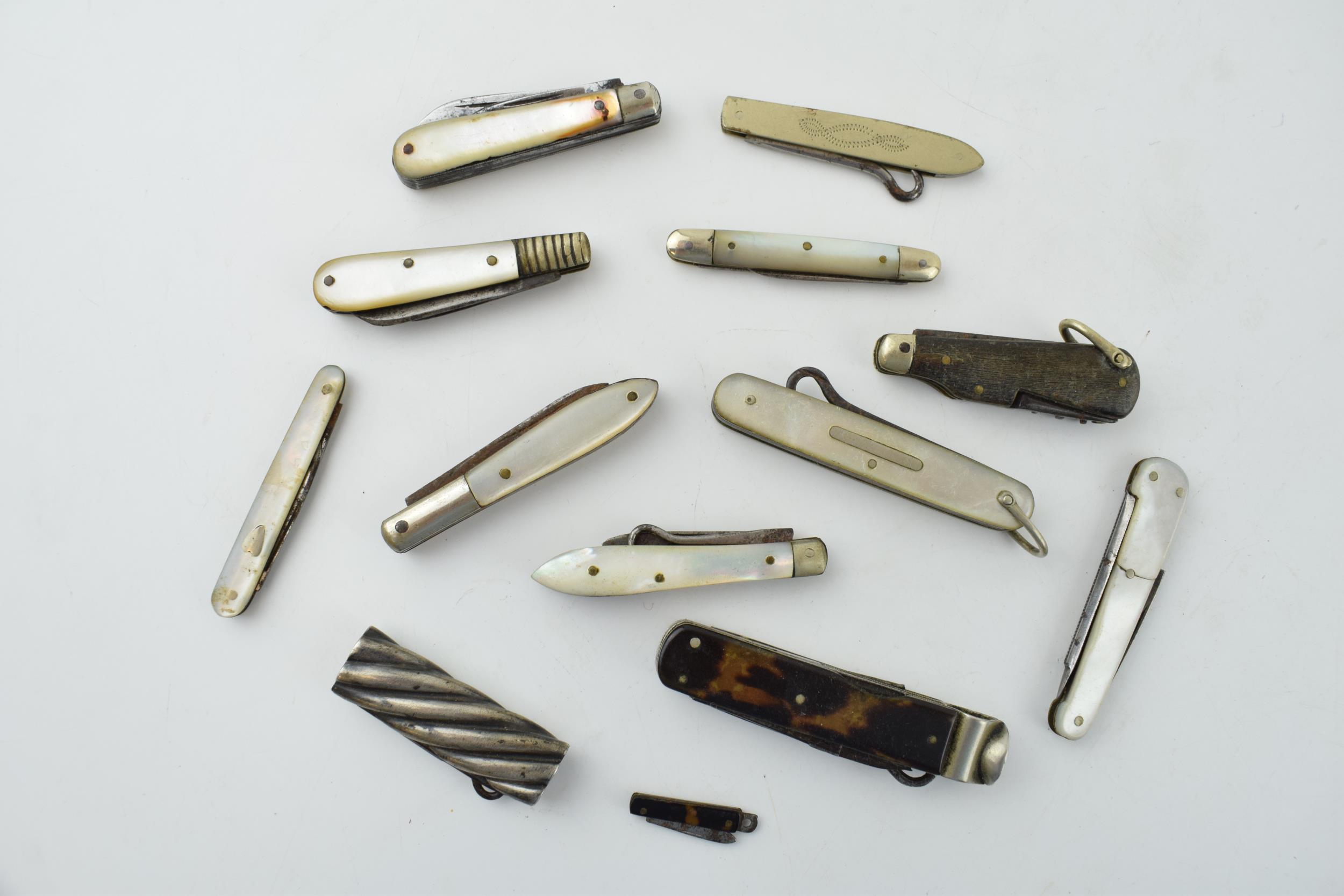 A collection of antique multifunction tool pocket knives to include mother pot pearl handled example