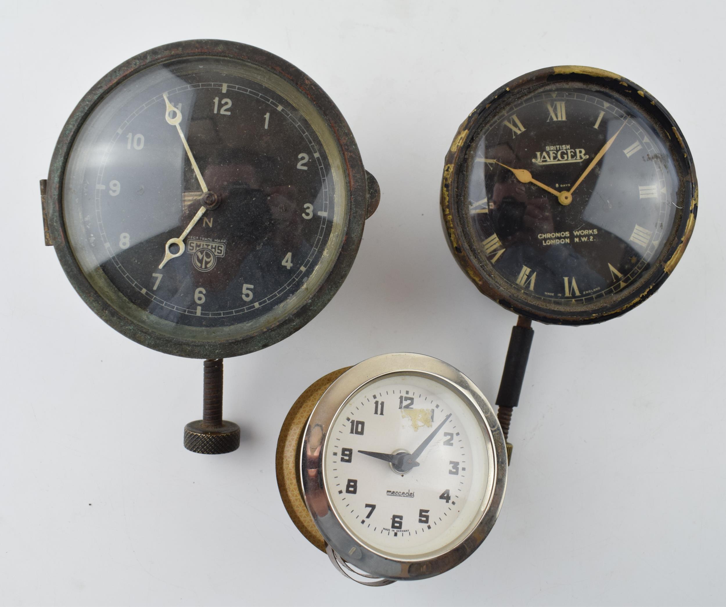 A collection of car clocks to include examples by Smiths, Jaeger and Mercedes. (3) All wind and
