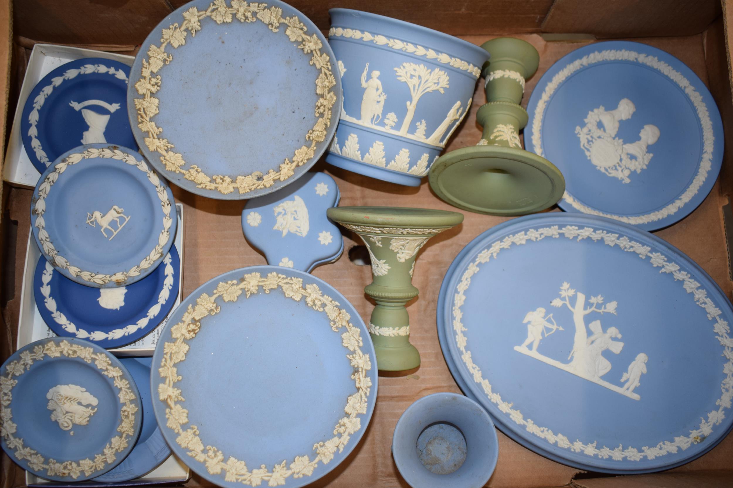 Wedgwood Jasperware in green and blue to include a pair of candlesticks, tazzas, vases, an oval