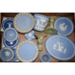Wedgwood Jasperware in green and blue to include a pair of candlesticks, tazzas, vases, an oval