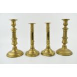 Two pairs of early brass candle sticks with spun bases. One pair benefiting from having height