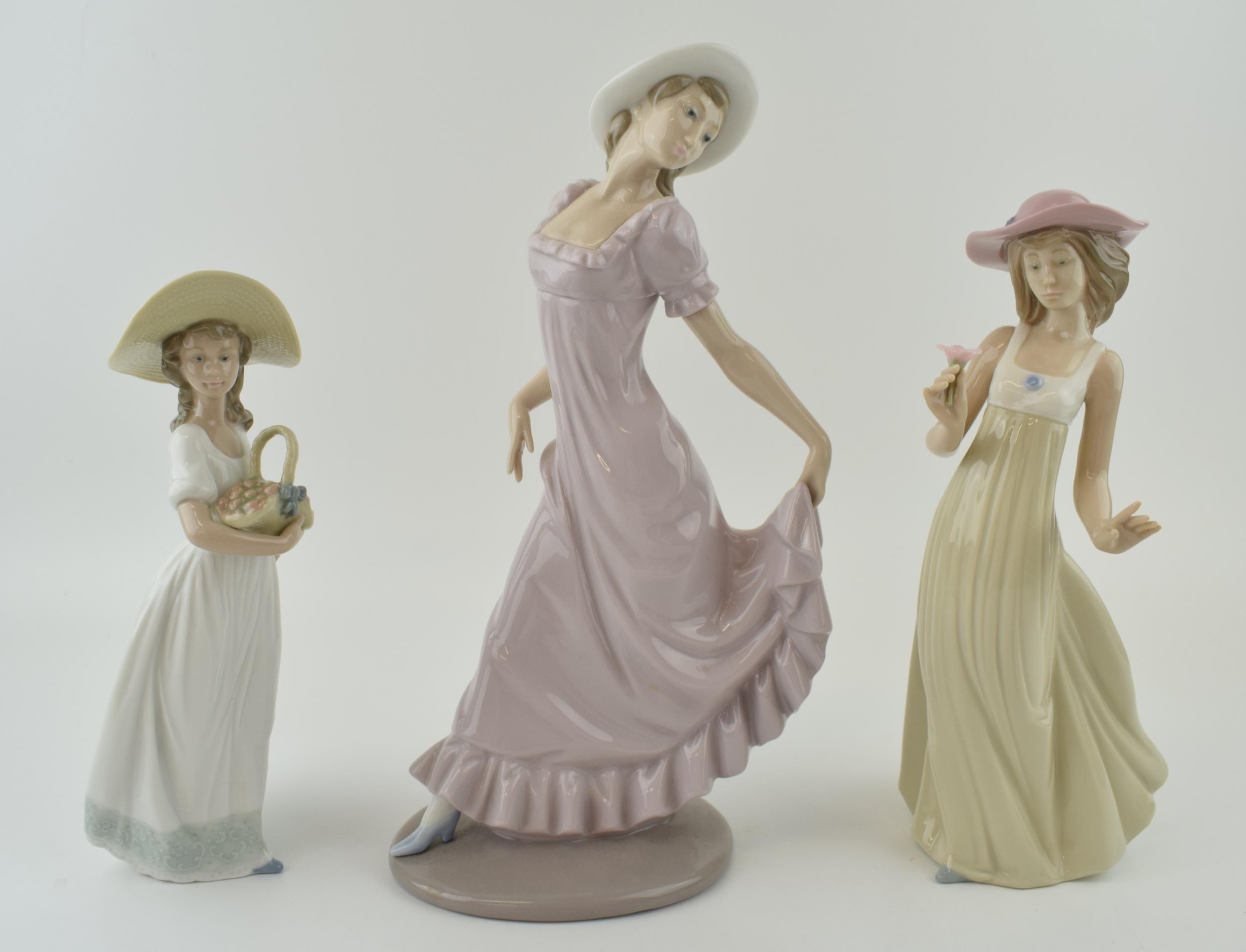 Nao figures to include a girl in a purple dress a girl with a basket of flowers and a girl holding a