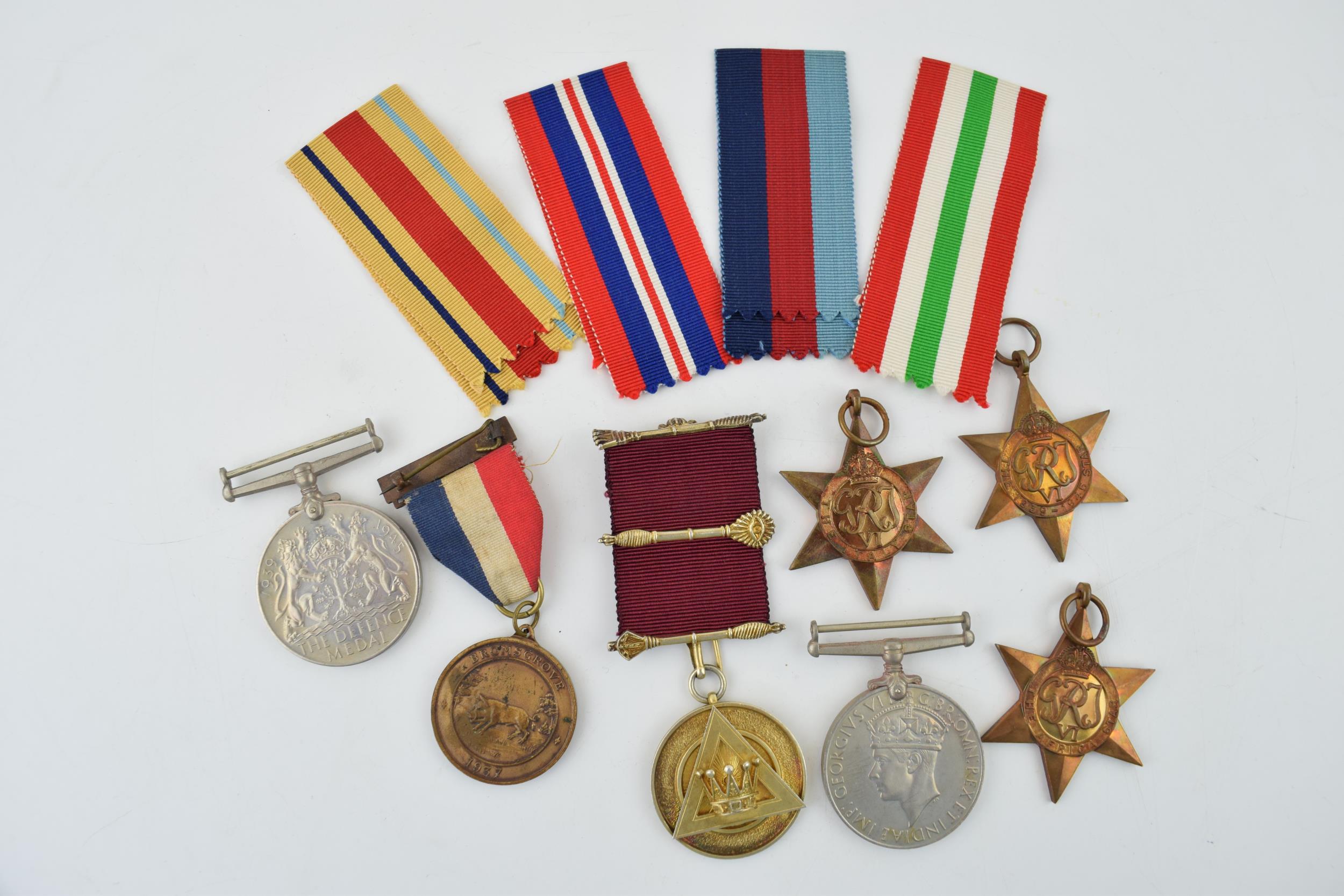 A collection of WWII medals (5) in original paper sleeves together with a silver Masonic medal and a