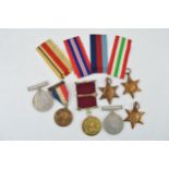 A collection of WWII medals (5) in original paper sleeves together with a silver Masonic medal and a