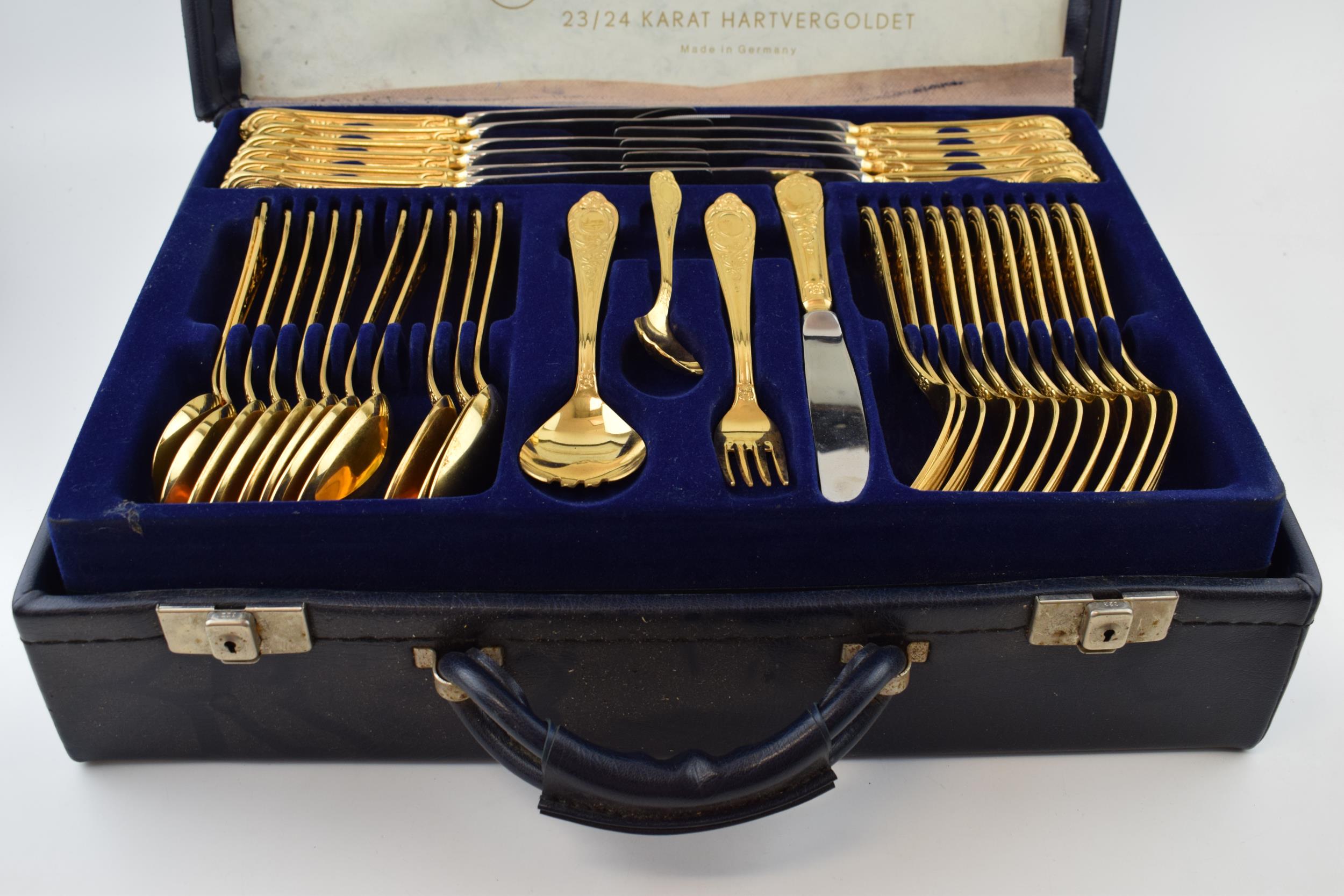 A cased Solingen 24k gold plated cutlery set, in leather brief case, with 3 trays of cutlery, all in