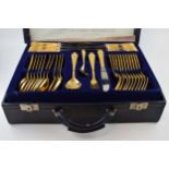 A cased Solingen 24k gold plated cutlery set, in leather brief case, with 3 trays of cutlery, all in