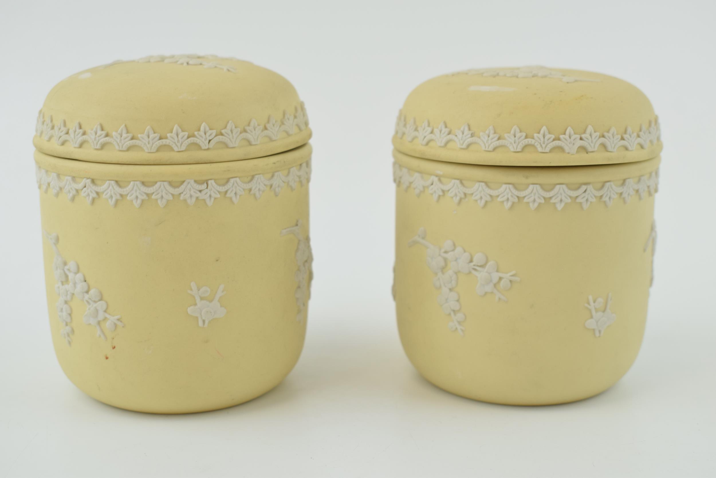 A pair of Wedgwood Jasperware in the yellow / prunus colour, lidded pots, 9.5cm tall. In good