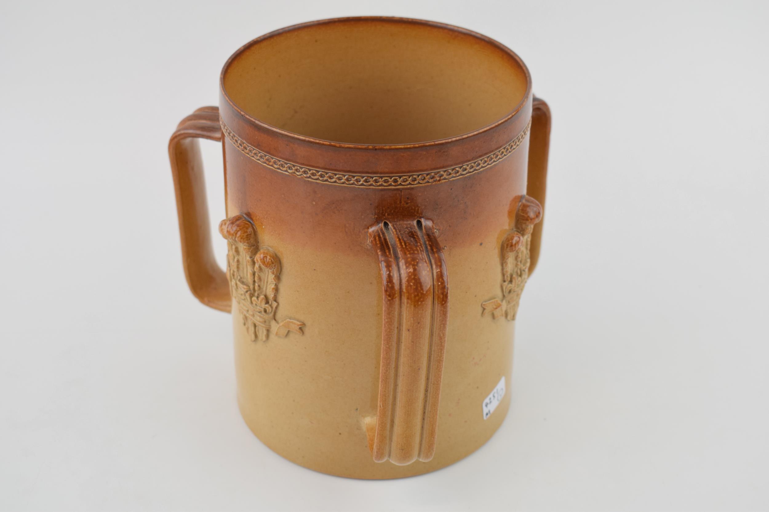 A stoneware loving cup with Fleur-de-lis design. Marked 'Doulton Lambeth' to base with 'John - Image 2 of 3