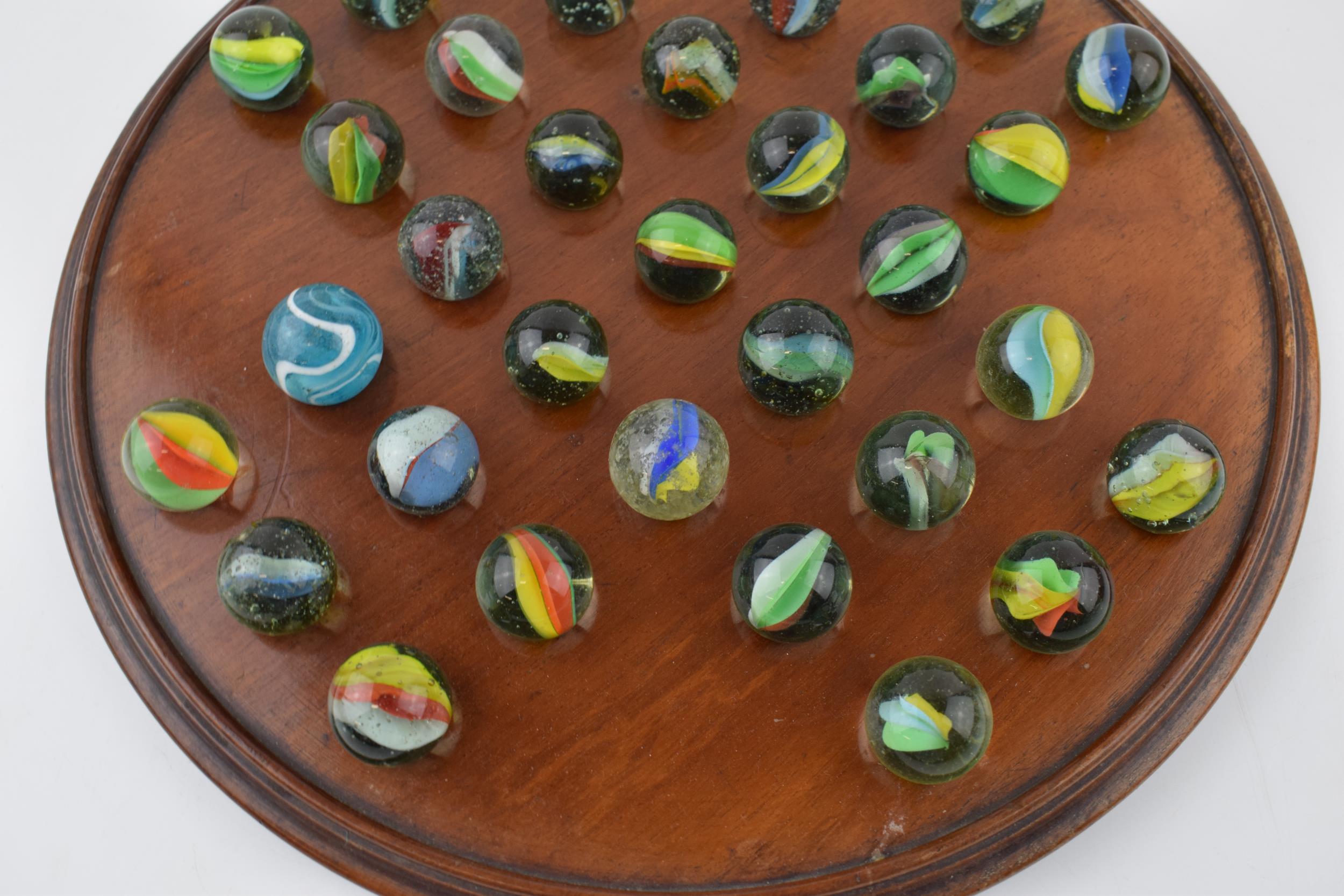 An antique solitaire board with associated marbles. Diameter 30cm. With some light water damage / - Image 3 of 5