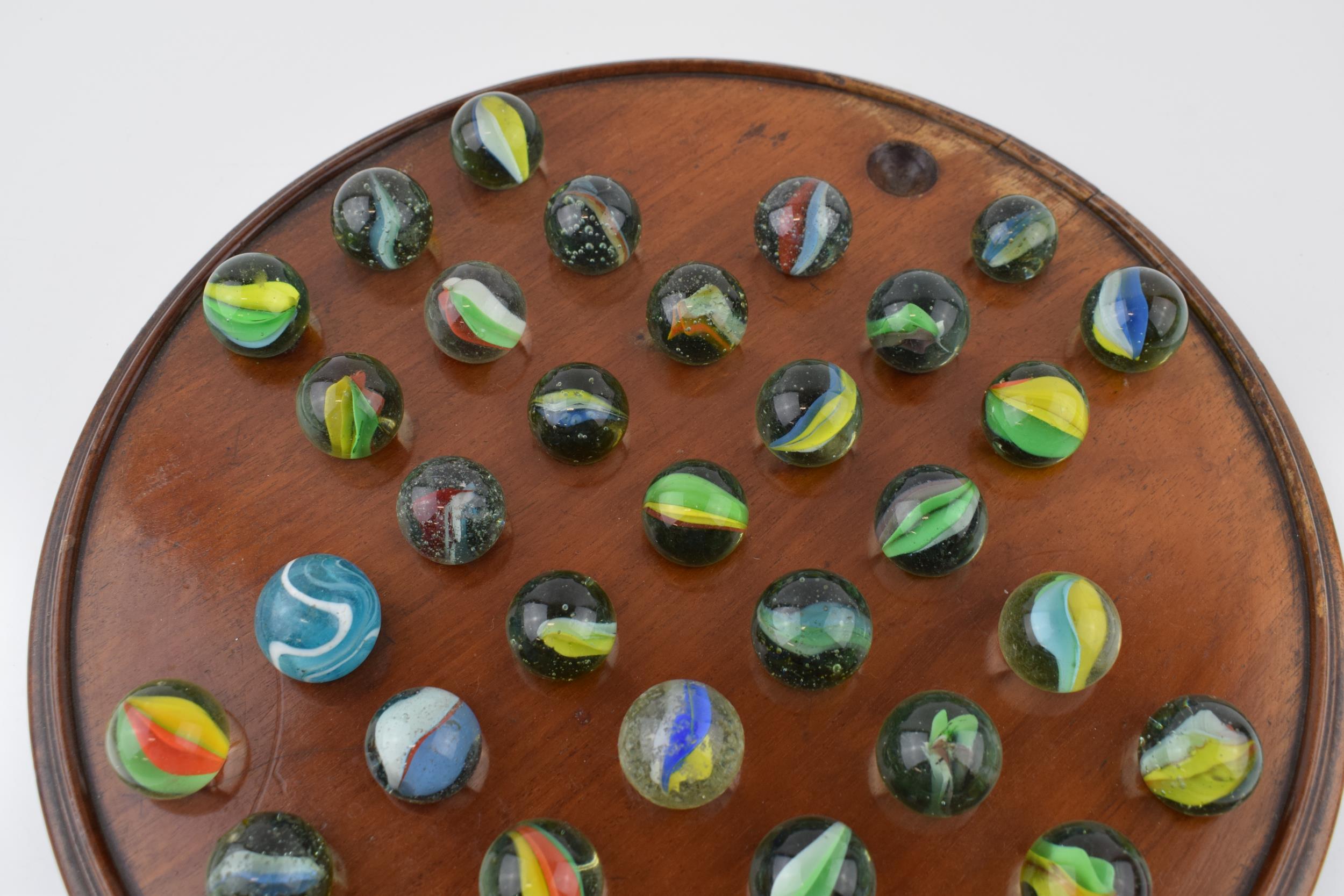 An antique solitaire board with associated marbles. Diameter 30cm. With some light water damage / - Image 2 of 5