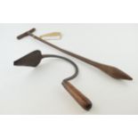 An antique metal dibble together with another wooden handled gardening / farming tool. Length