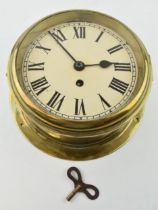 Antique bulkhead clock with brass case. Mechanical movement. Original glass, lockable clasp to outer