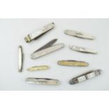 A collection of mother of pearl handled penknives, pipe tempers and pocket knives to include