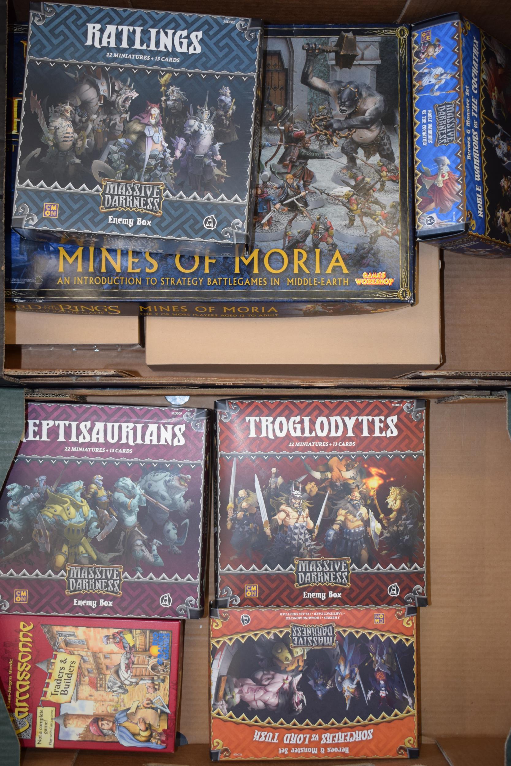 A collection of empty boxes from strategy games to include Warhammer , Lord of the Rings and similar