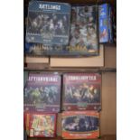 A collection of empty boxes from strategy games to include Warhammer , Lord of the Rings and similar