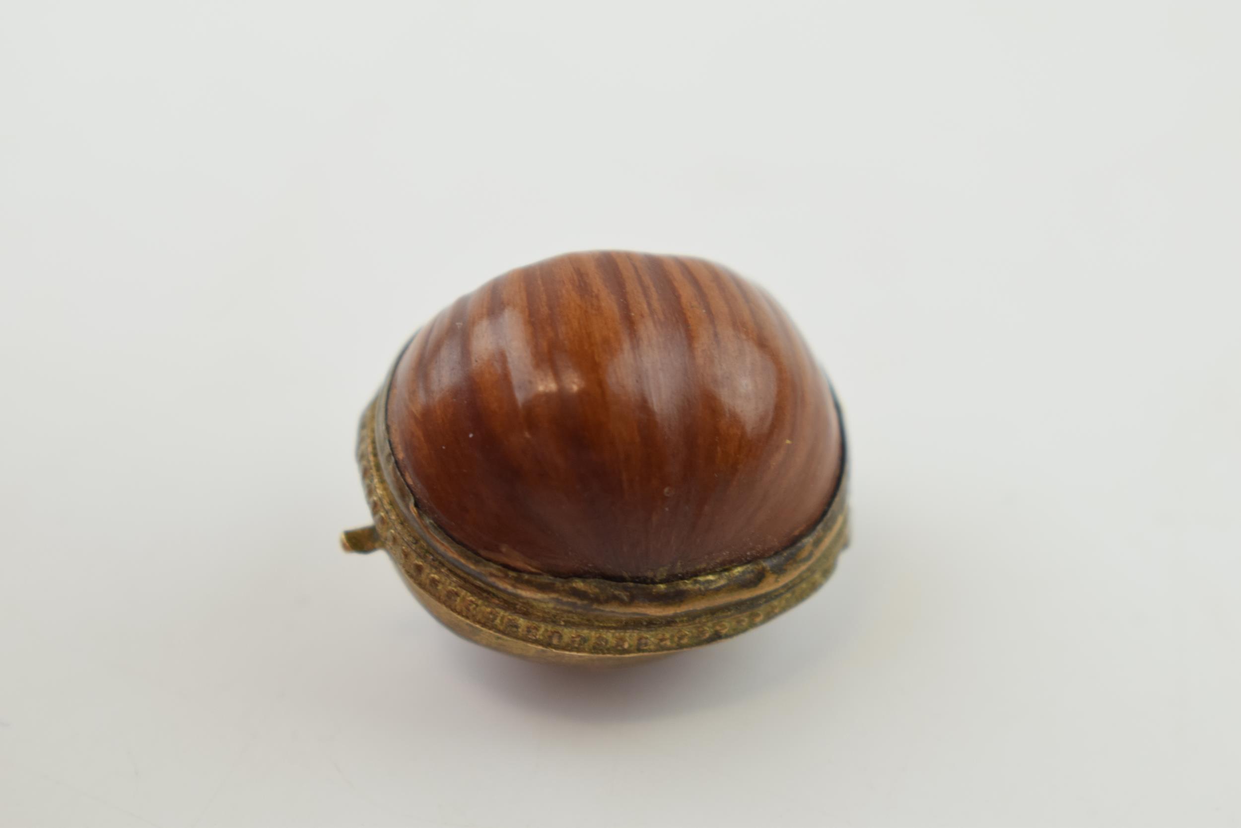 A miniature purse made form a hazelnut shell with brass hinge and mount. 2.5cm. - Image 2 of 4