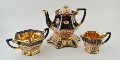 An early 20th century teaset, potentially Gibsons, to include a teapot, a stand, a sugar and a