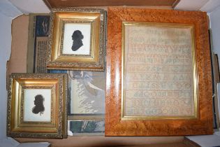 A 19th century sampler dated 1882 together with a pair of silhouettes. Items are in later frames.