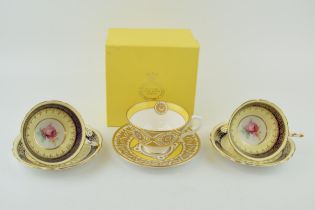 Three cups and saucers to include a boxed example by 'The Royal Collection' together with two '