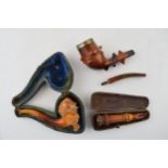 A collection of smoking related items to include a Briar pipe with hallmarked silver mount and amber
