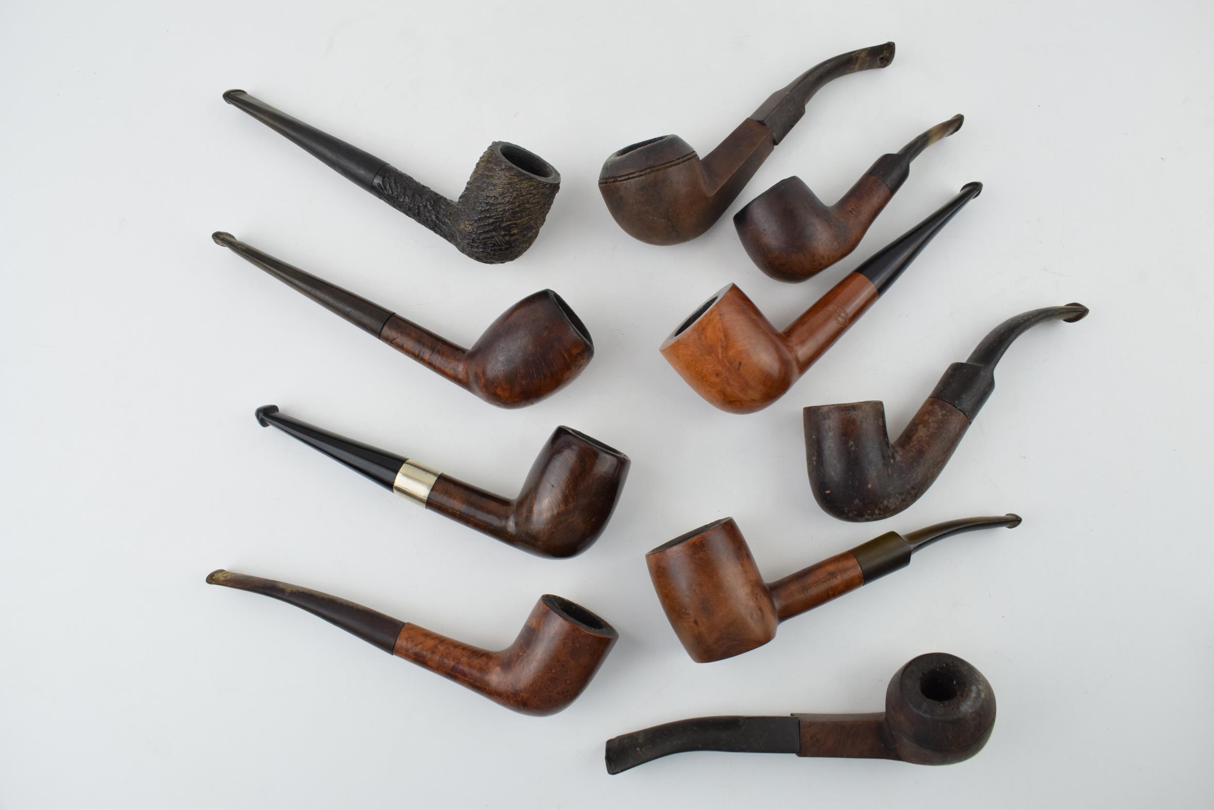 A collection of vintage tobacco smoking pipes to include briar examples by 'Invicta', 'Riseagle