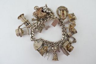 Hallmarked silver charm, heavy, with charms to include a pram, a church, a well, a windmill and