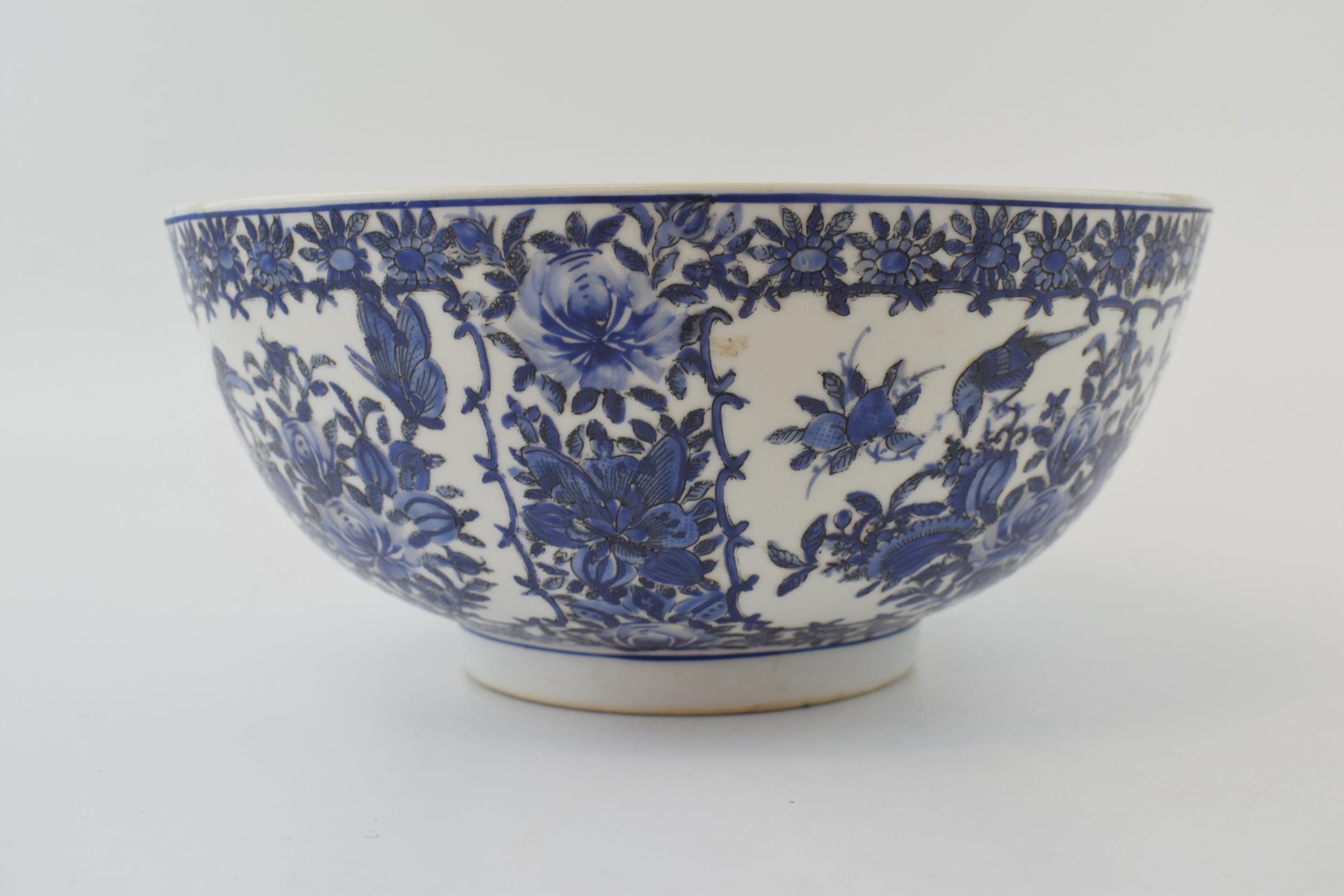 A large blue and white Chinese bowl with character marks to the base. 10” wide. In good condition.
