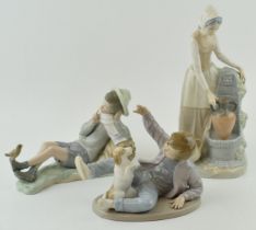 A trio of figures to include a Lladro boy with a bird on his foot (bird glued back), with a pair