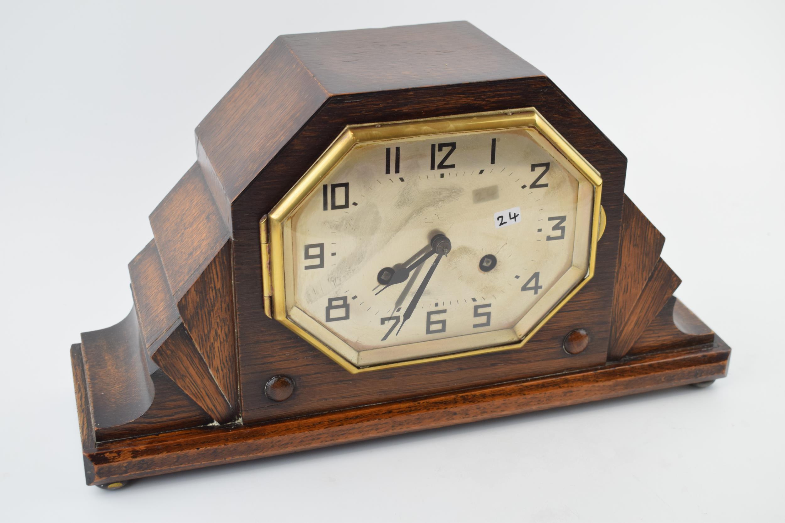 An Art Deco mantle clock with chiming movement. With pendulum and key. Height 20cm. winds, runs