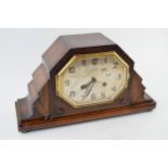 An Art Deco mantle clock with chiming movement. With pendulum and key. Height 20cm. winds, runs