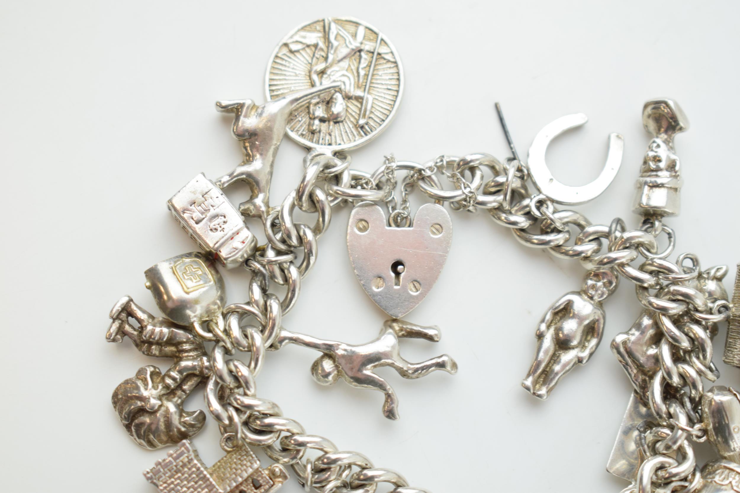 Silver charm bracelet with a church, a bear, people, a tankard and others, 81.6 grams. - Image 3 of 4